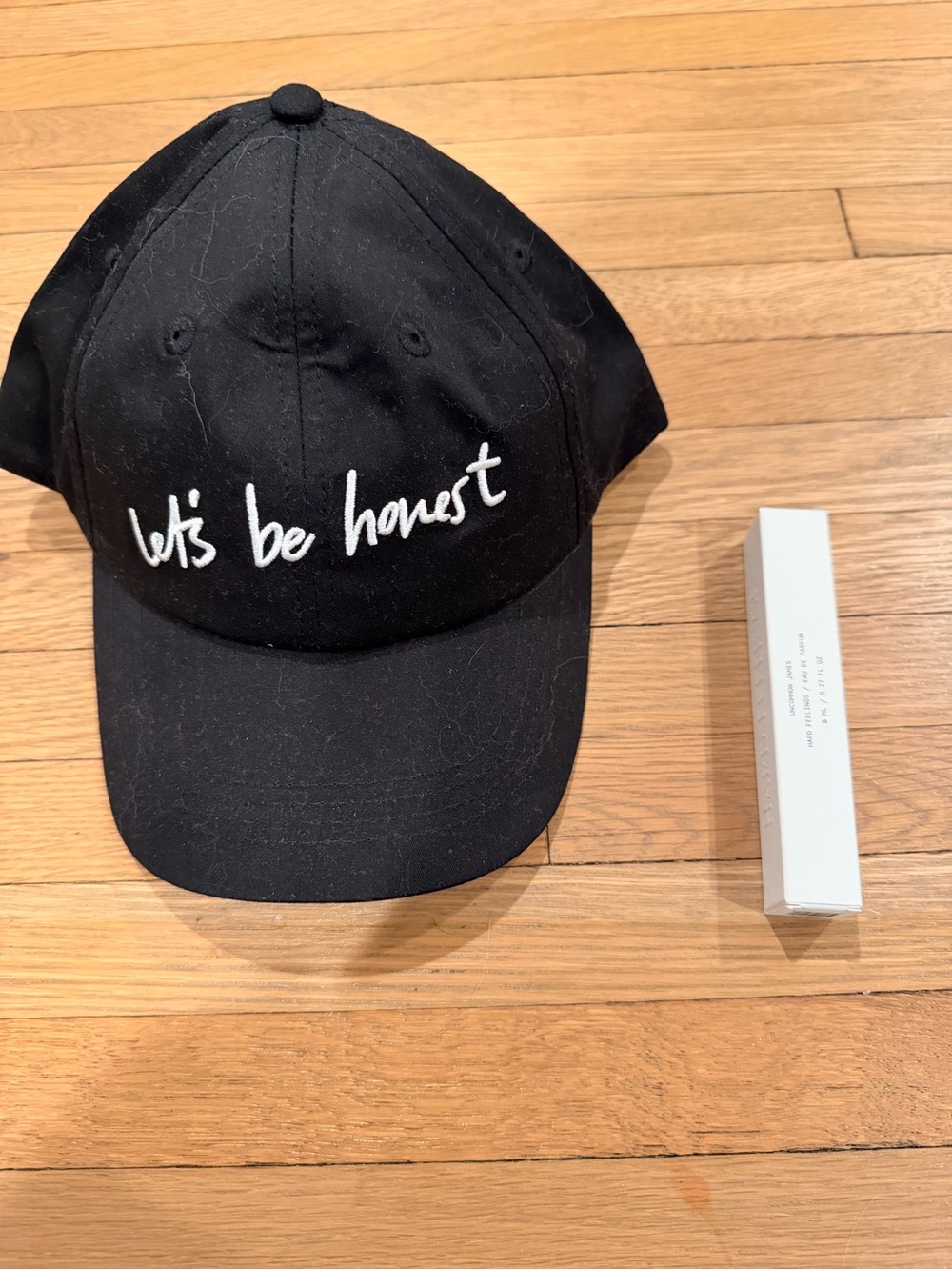 Uncommon James Black Baseball Cap and Hard Feelings Perfume